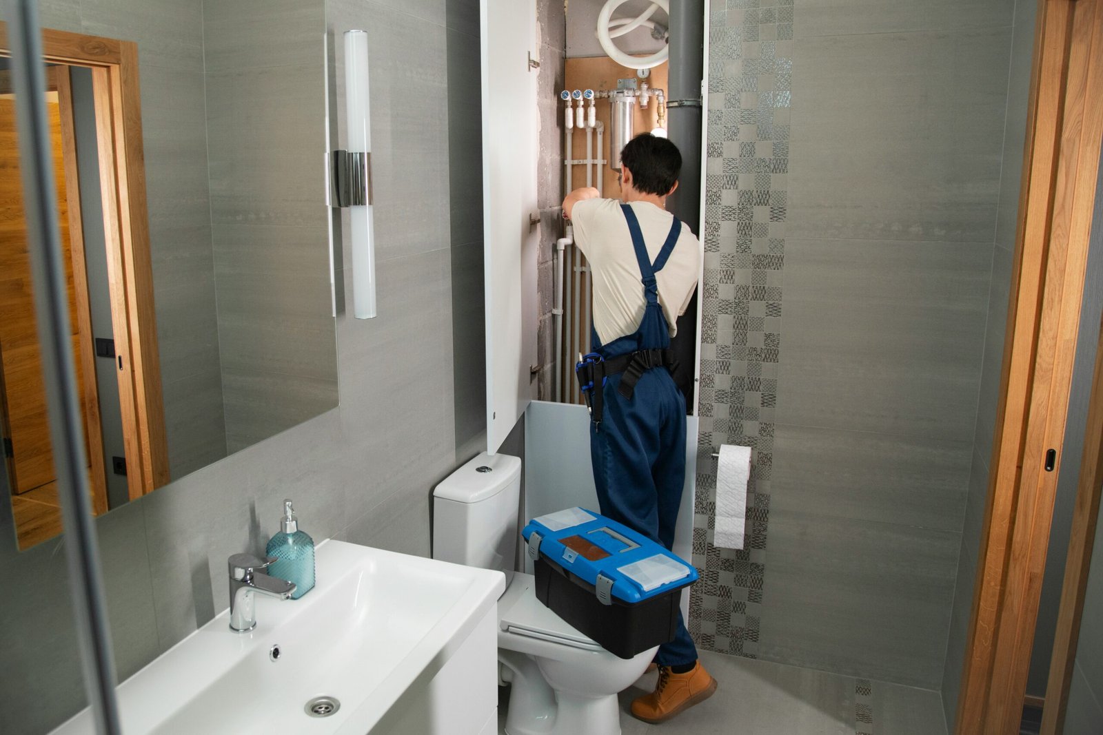 Homeowner consulting a professional plumber for home plumbing repairs